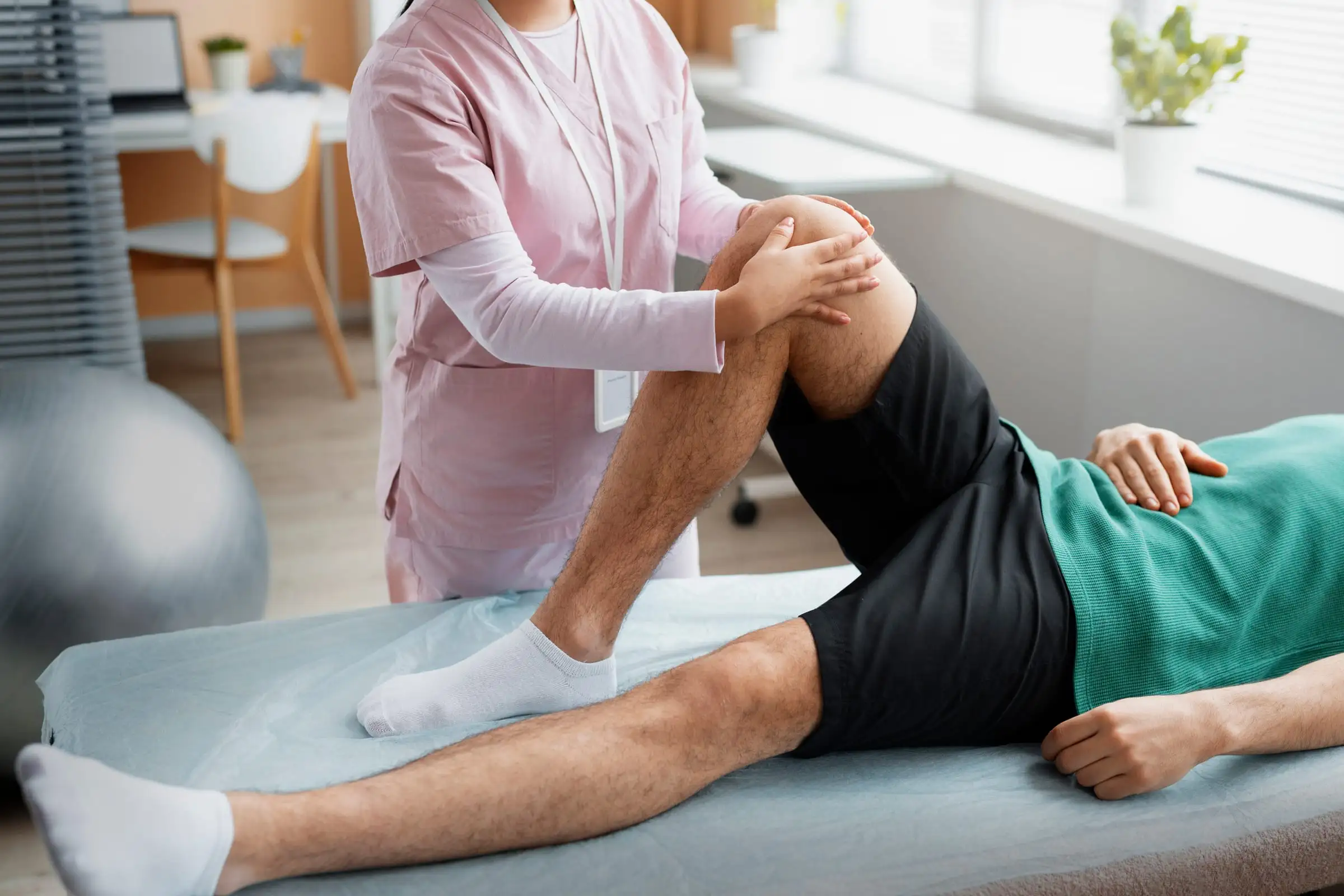 Profissional de reabilitação conduzindo exercício de perna em uma maca
